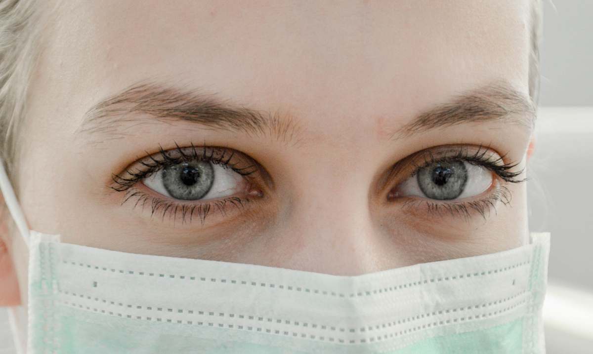 albanian university closeup photo of woman's eye wearing mask tirana